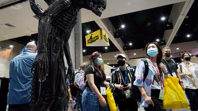 A Comic-Con attendee walks past a life-size model of the creature from the "Alien" movie franchise during Preview Night at the 2022 Comic-Con International at the San Diego Convention Center, Wednesday, July 20, 2022, in San Diego.